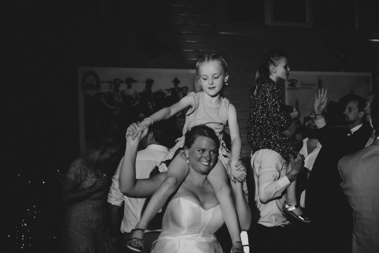 Wedding reception dance party captured in black and white photography.