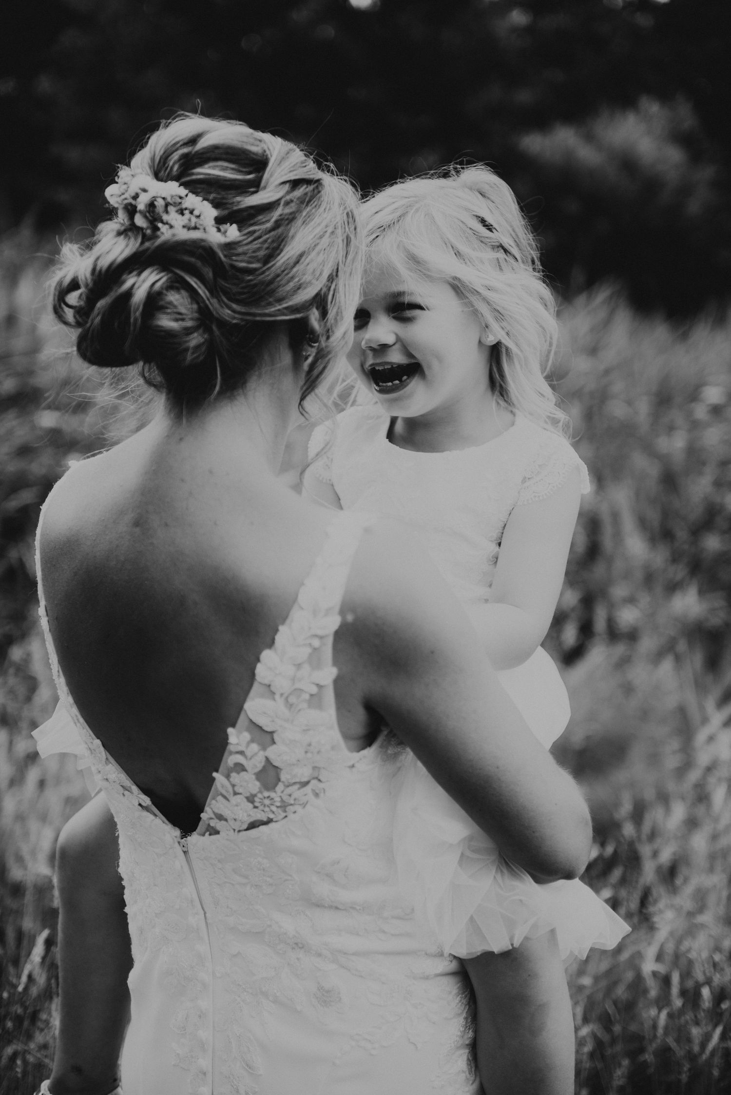 Black and white candid moments of joyful wedding party.