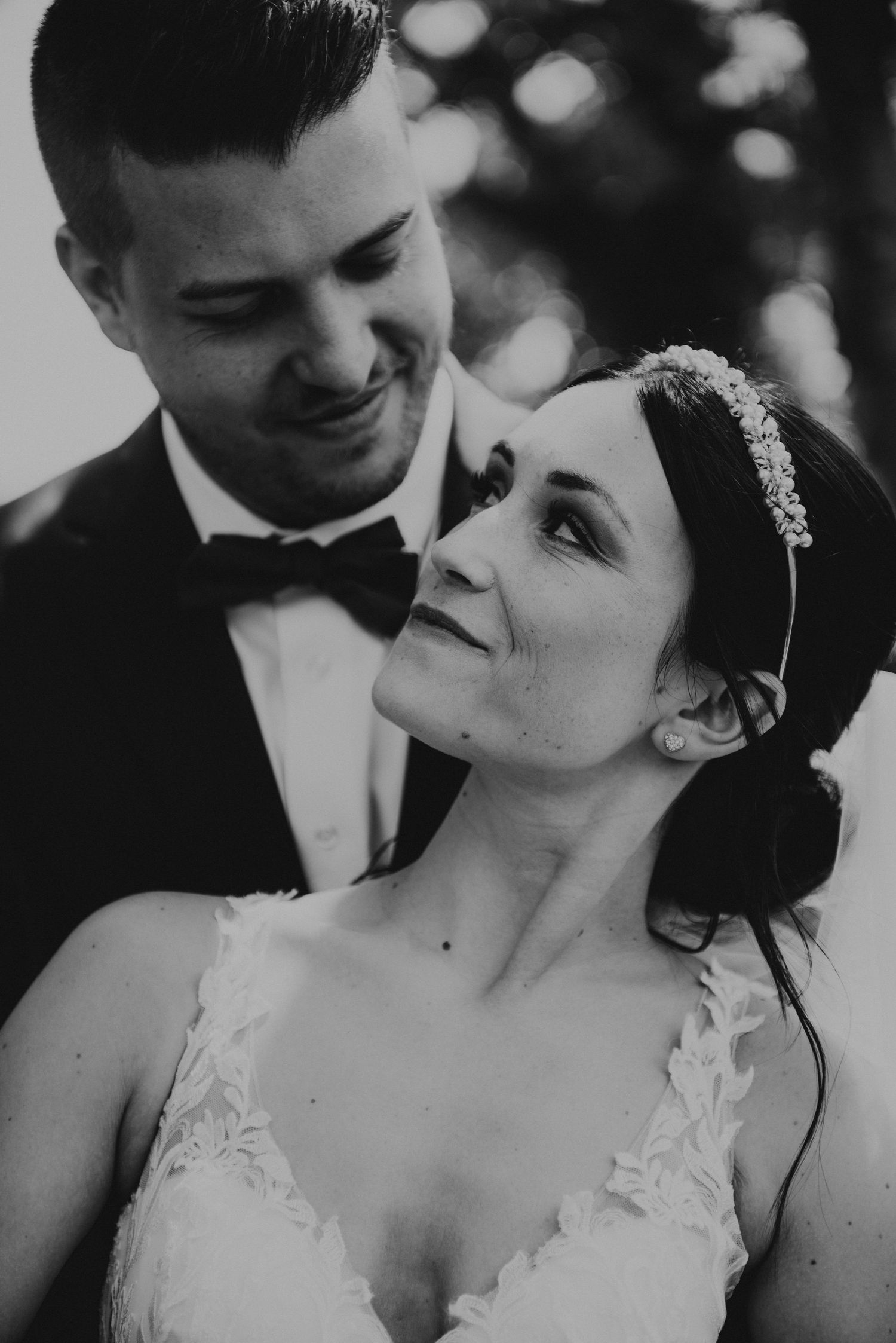 Black and white portrait of newlyweds sharing intimate moment.