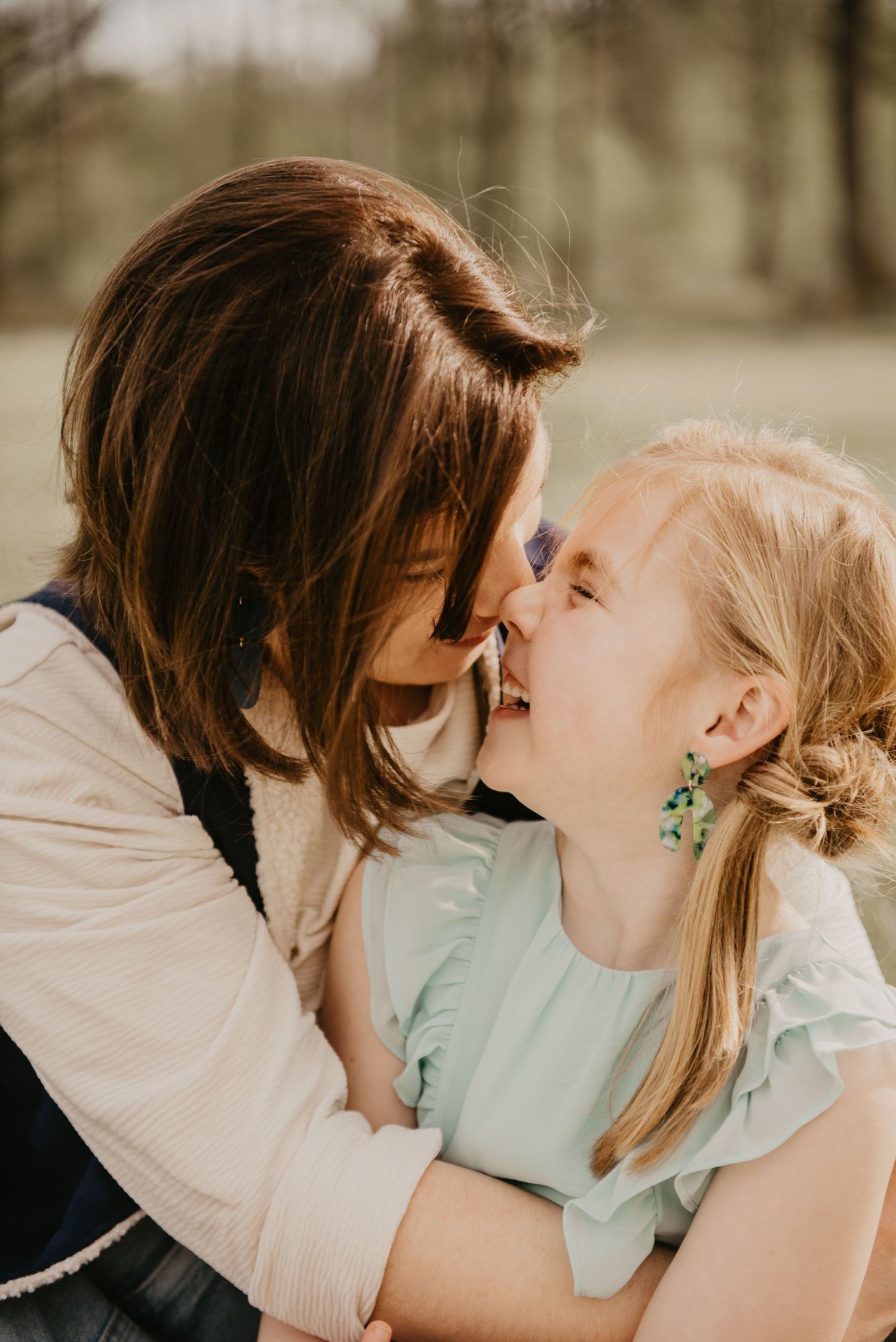 Tender moment shared between two people on a sunny afternoon outdoors.