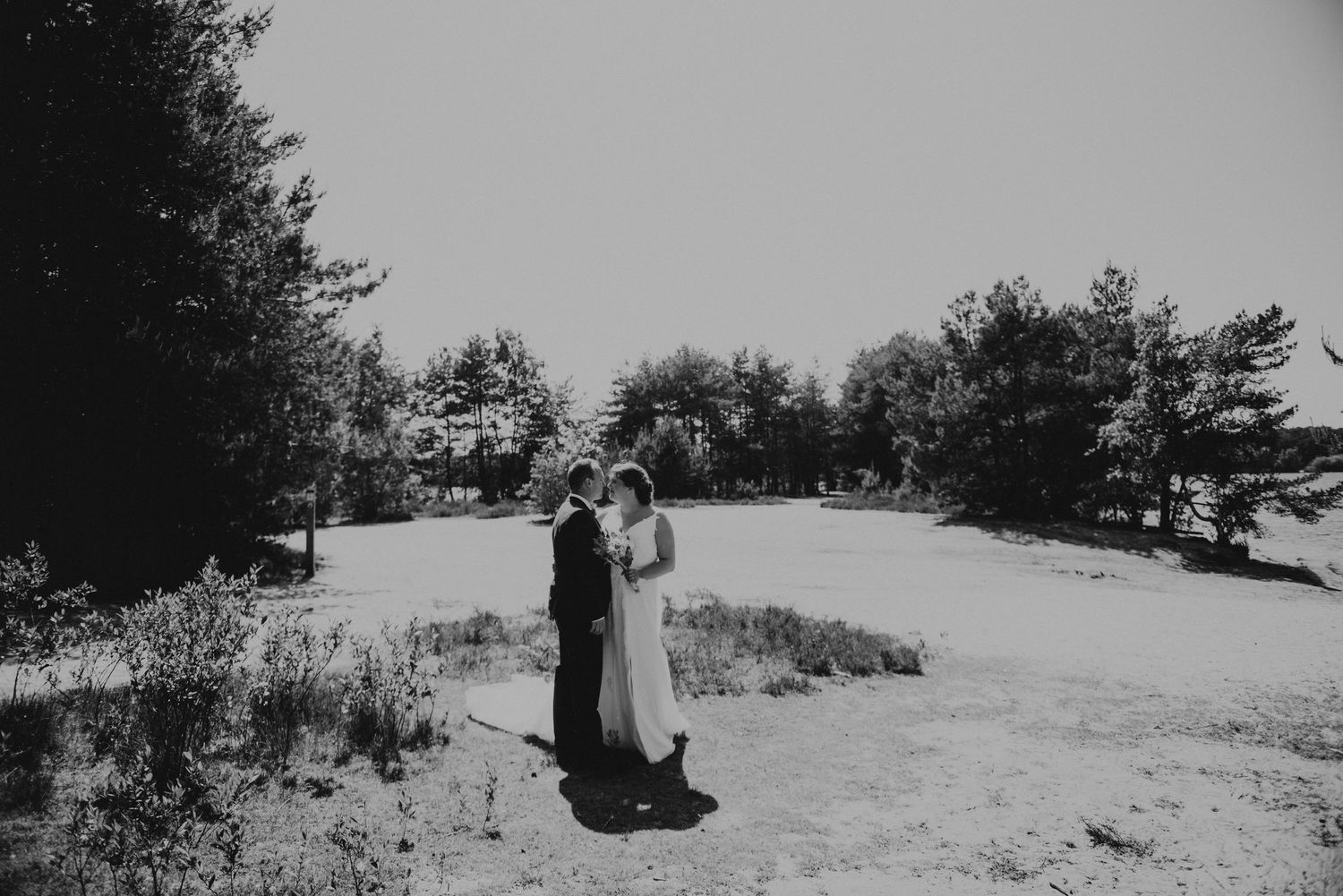 Winter wedding photography sequence showing couple embracing in snowy outdoor setting.