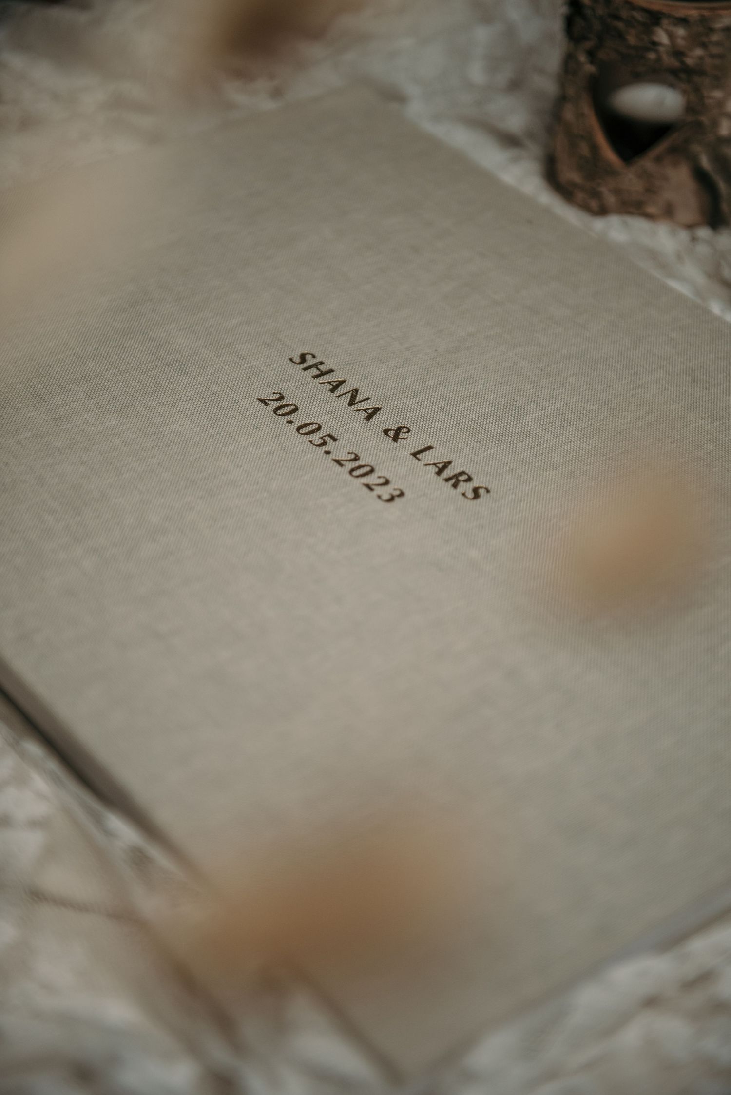Close-up of embossed text on a textured album cover surface.
