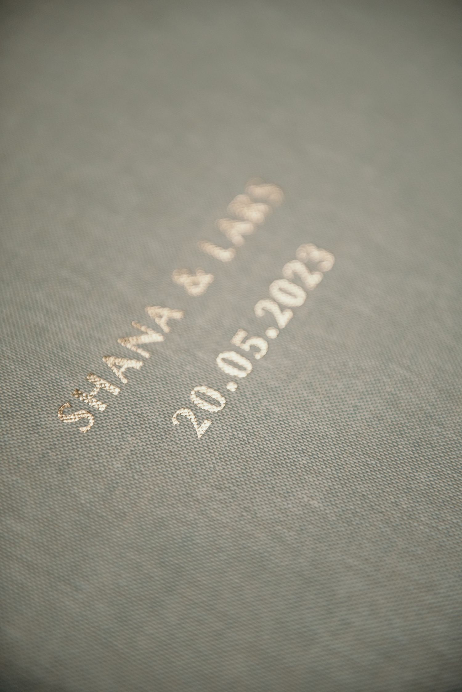 Macro shot of embossed numbers and text on a gray textured surface.