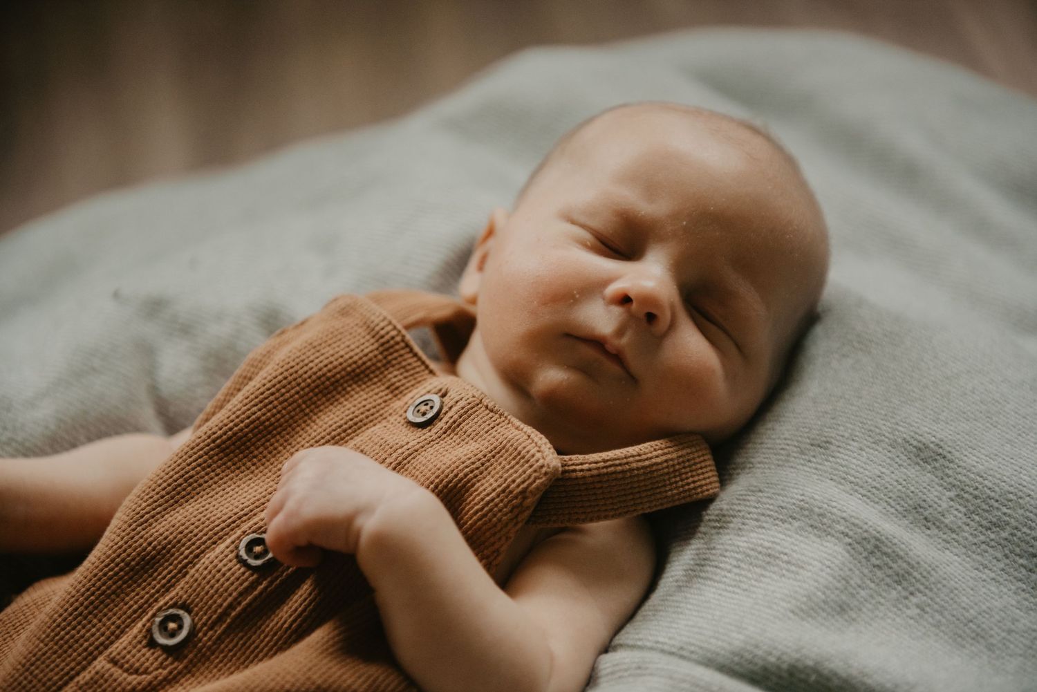 Close-up details of a sleeping baby wrapped in soft blankets.