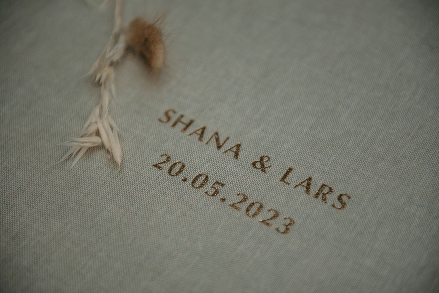 Vintage-style text engraving showing names and dates on a light surface.