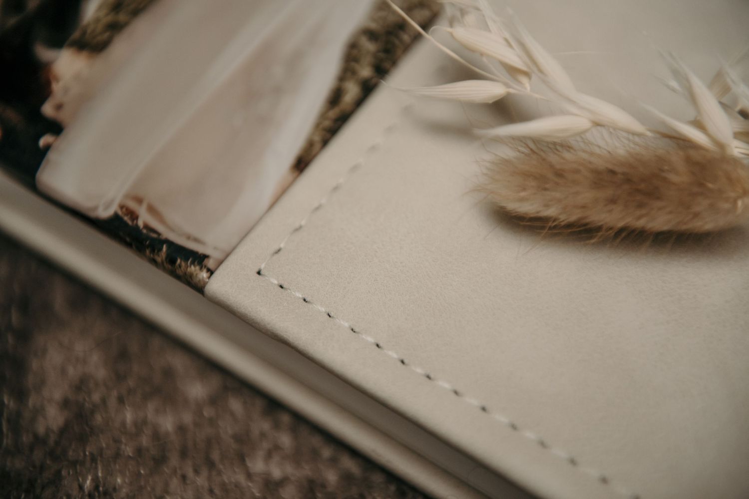 Close-up detail of a textured book cover or album with elegant design elements.