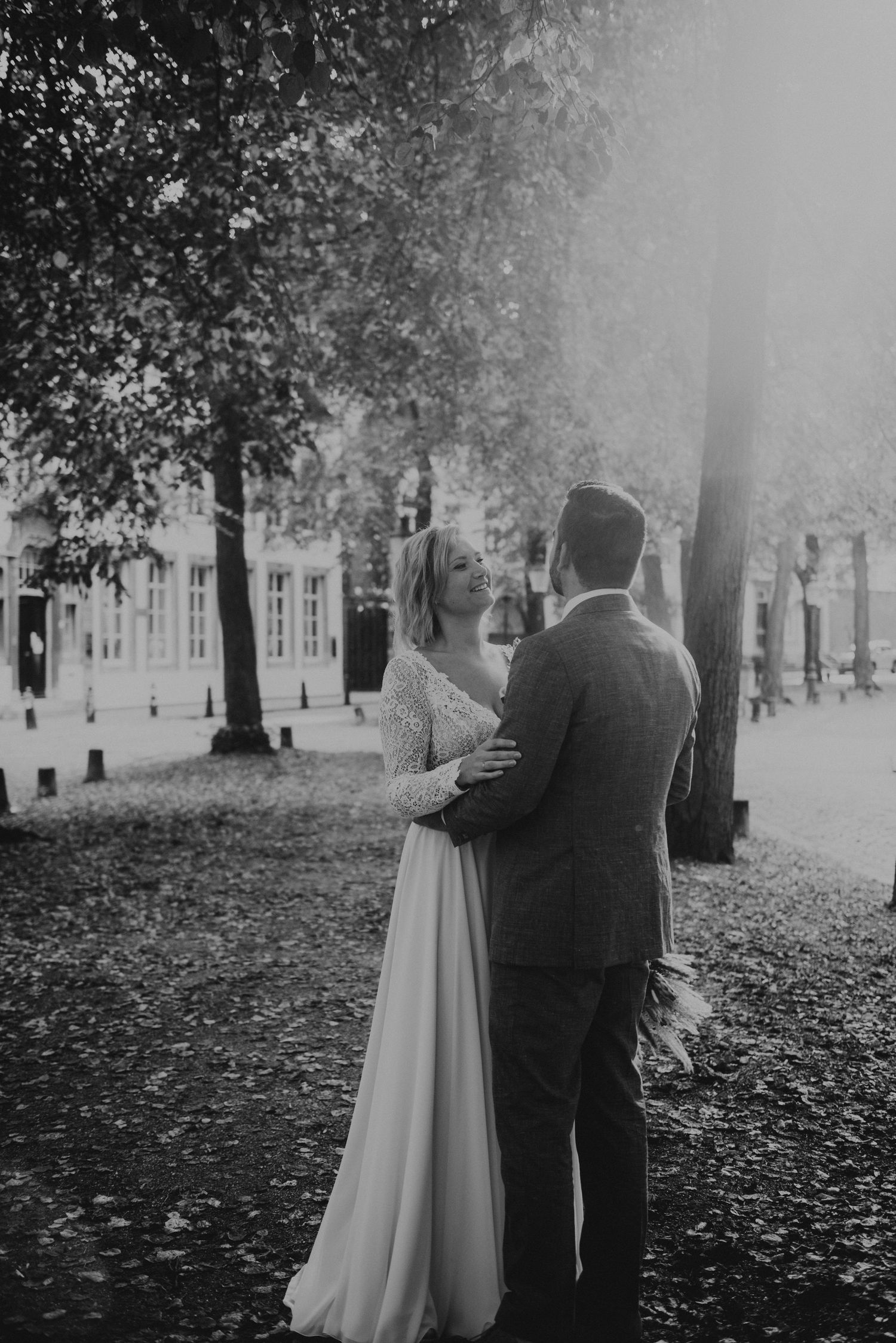 Misty autumn wedding scene with trees and fallen leaves.