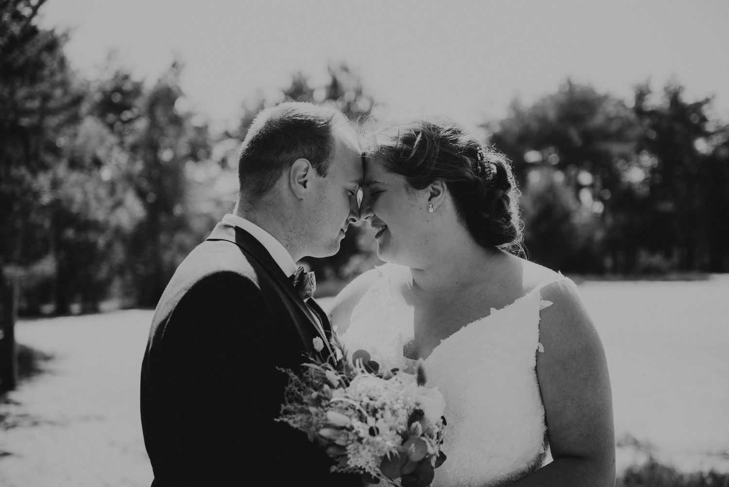 Black and white romantic wedding photos showing intimate moments in a snowy winter landscape.