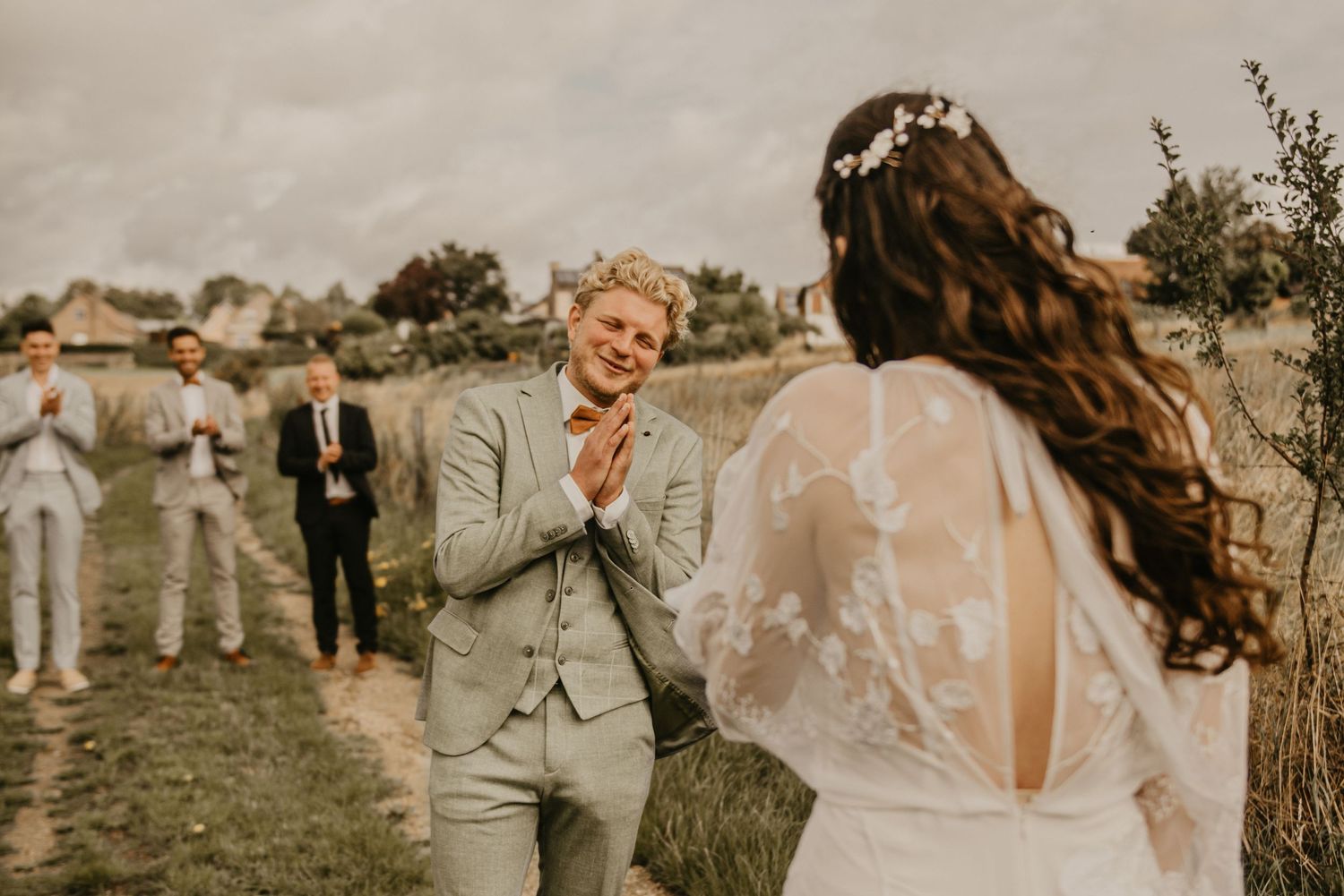 Wedding guests gathered outdoors in a natural setting during a ceremony.
