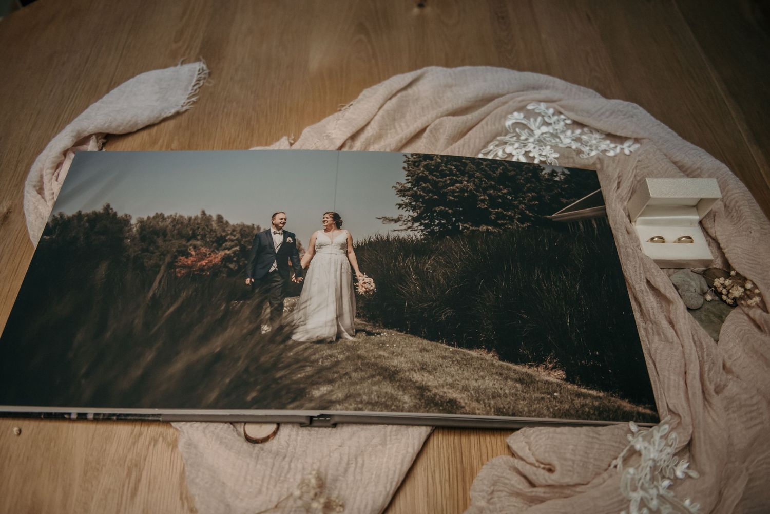 Wedding photo album spread showing landscape photography with artistic layout.