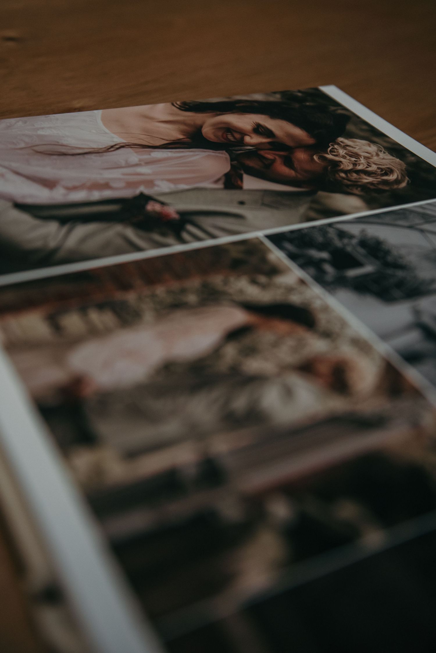 Close-up of wedding album pages with artistic photography layouts.