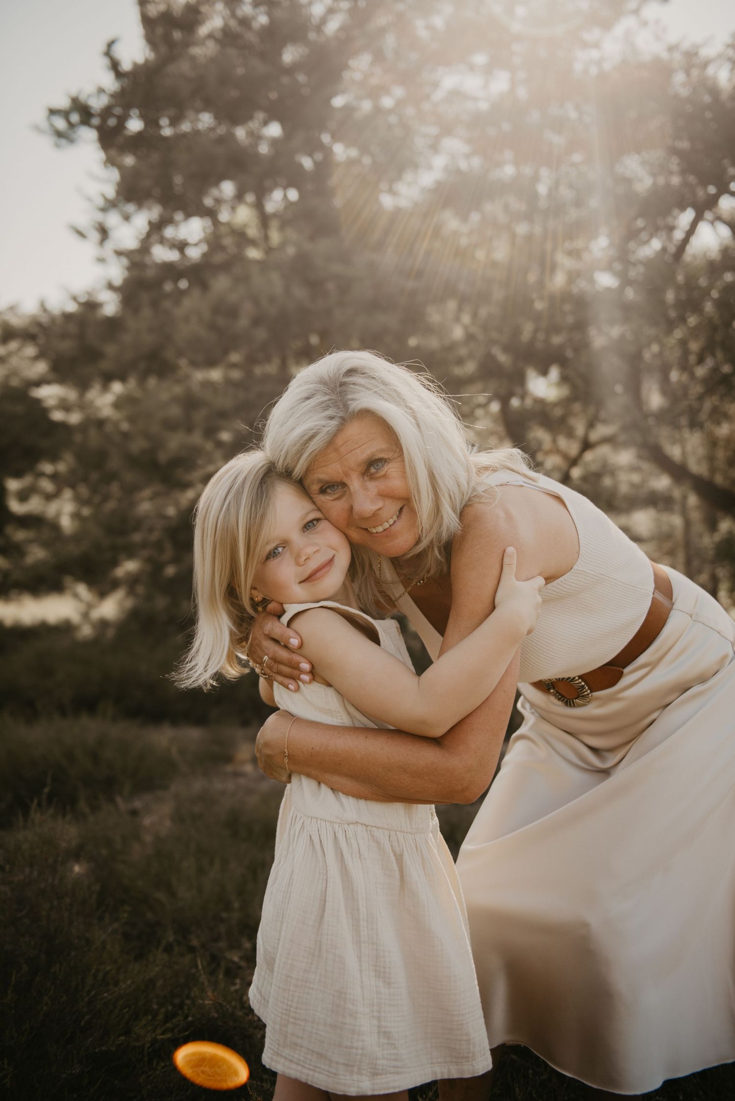 Heartwarming embrace between family members during sunset photo session.