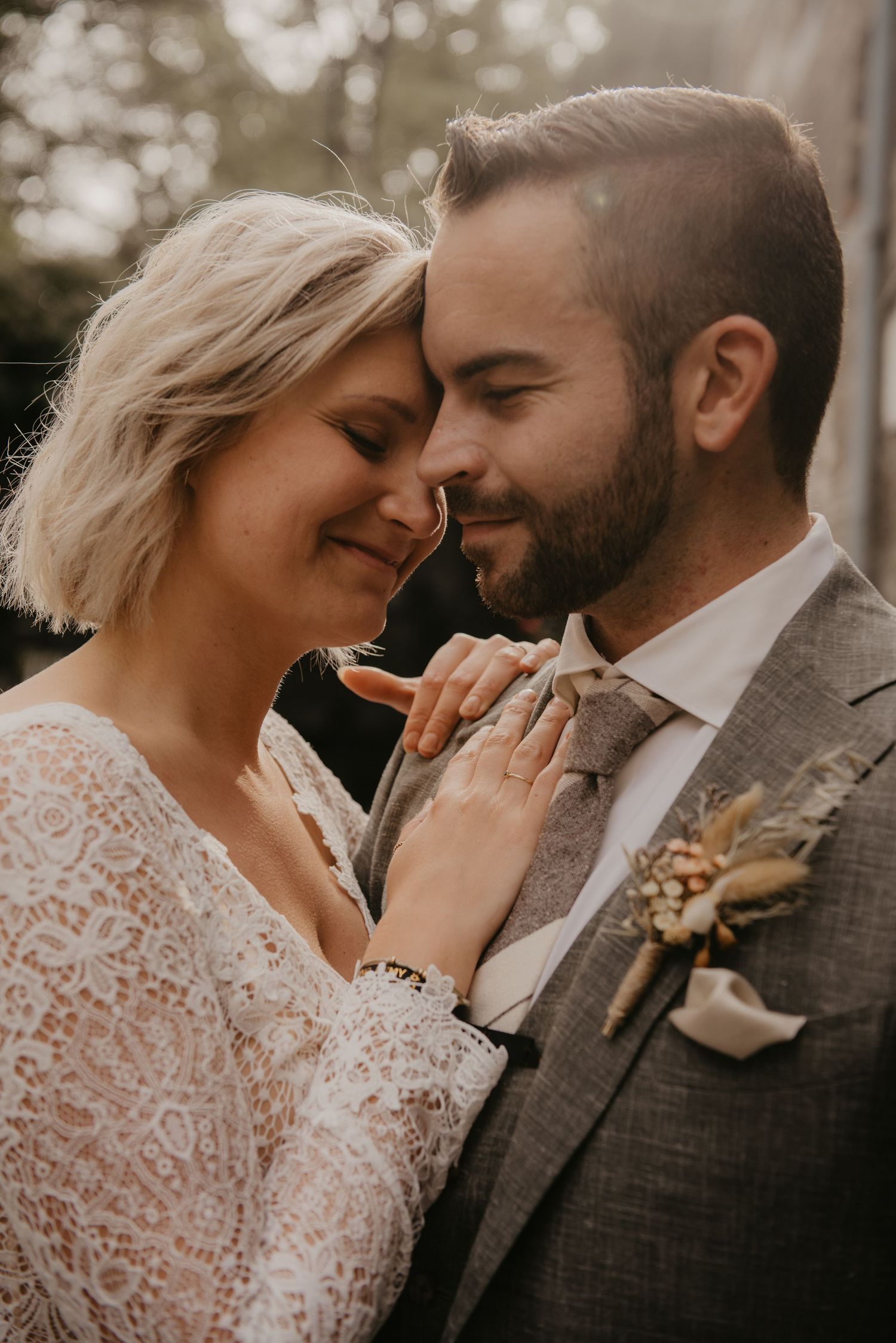 Intimate wedding portrait with lace dress details and autumn tones.