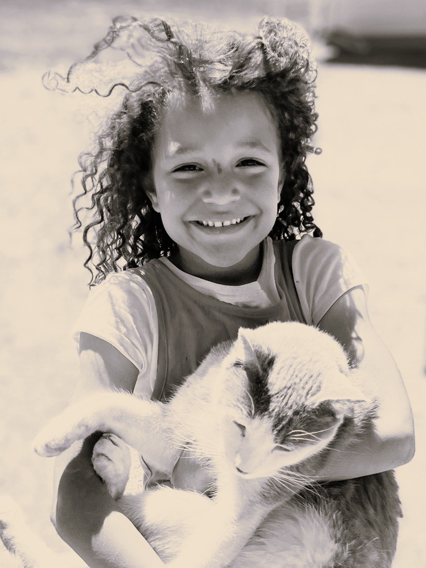 Black and white photograph showing a happy moment with a relaxed cat being held.