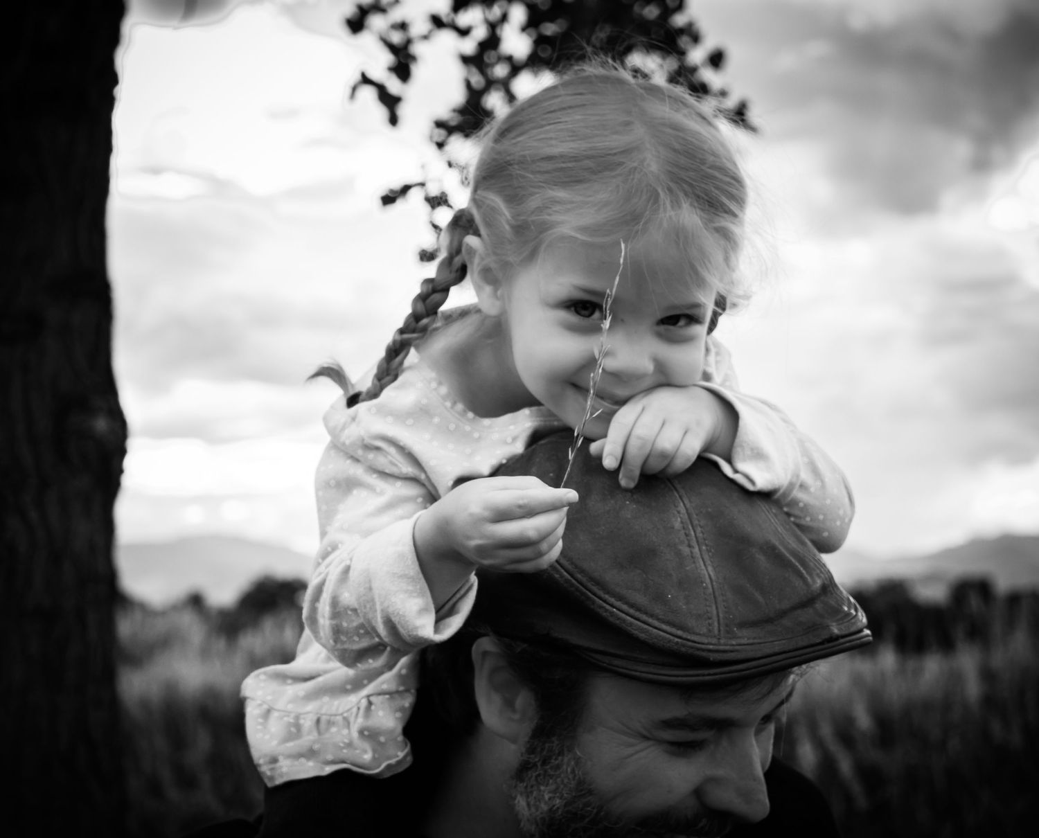 A sequence of black and white photos showing a child playfully covering their face with their hands.
