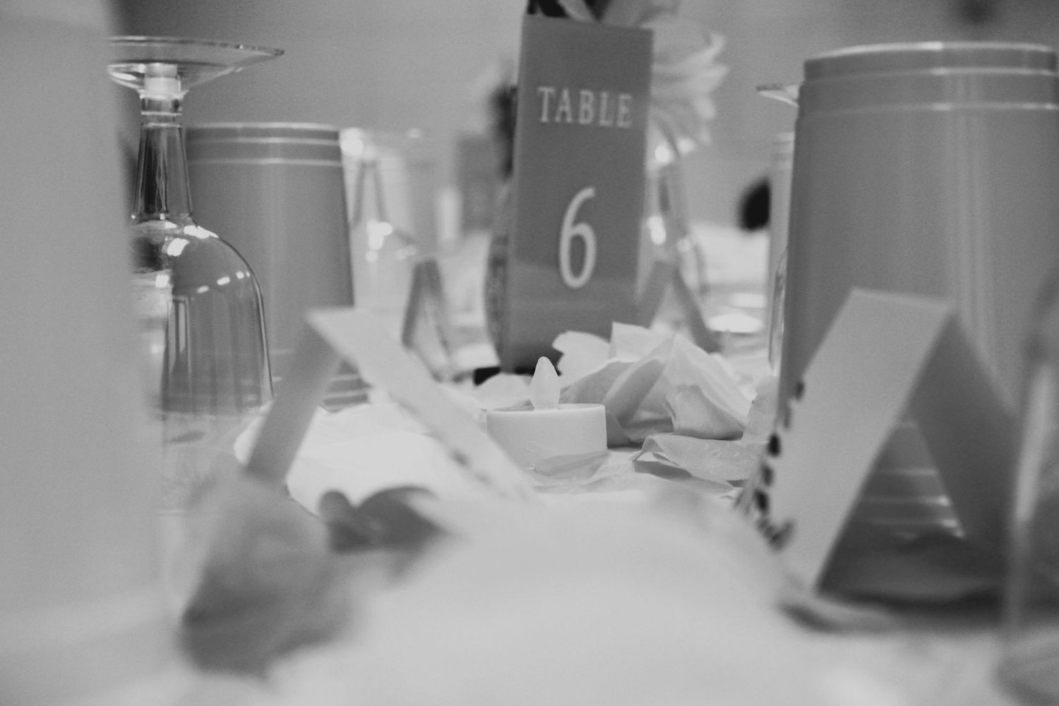 Artistic black and white photo of formal place settings at table number 6.