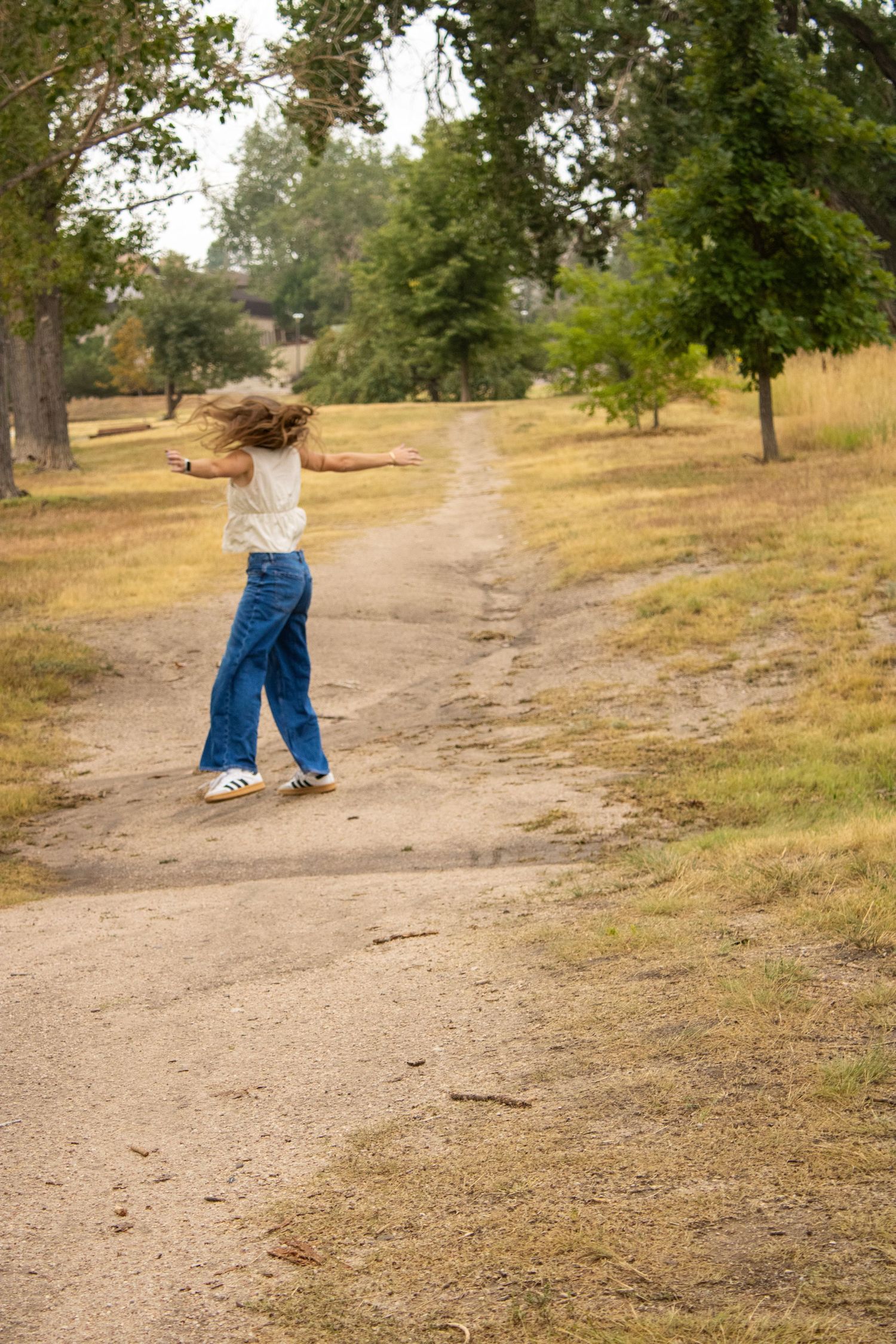 A series of photos showing someone walking down a dirt path through a rural hillside landscape.