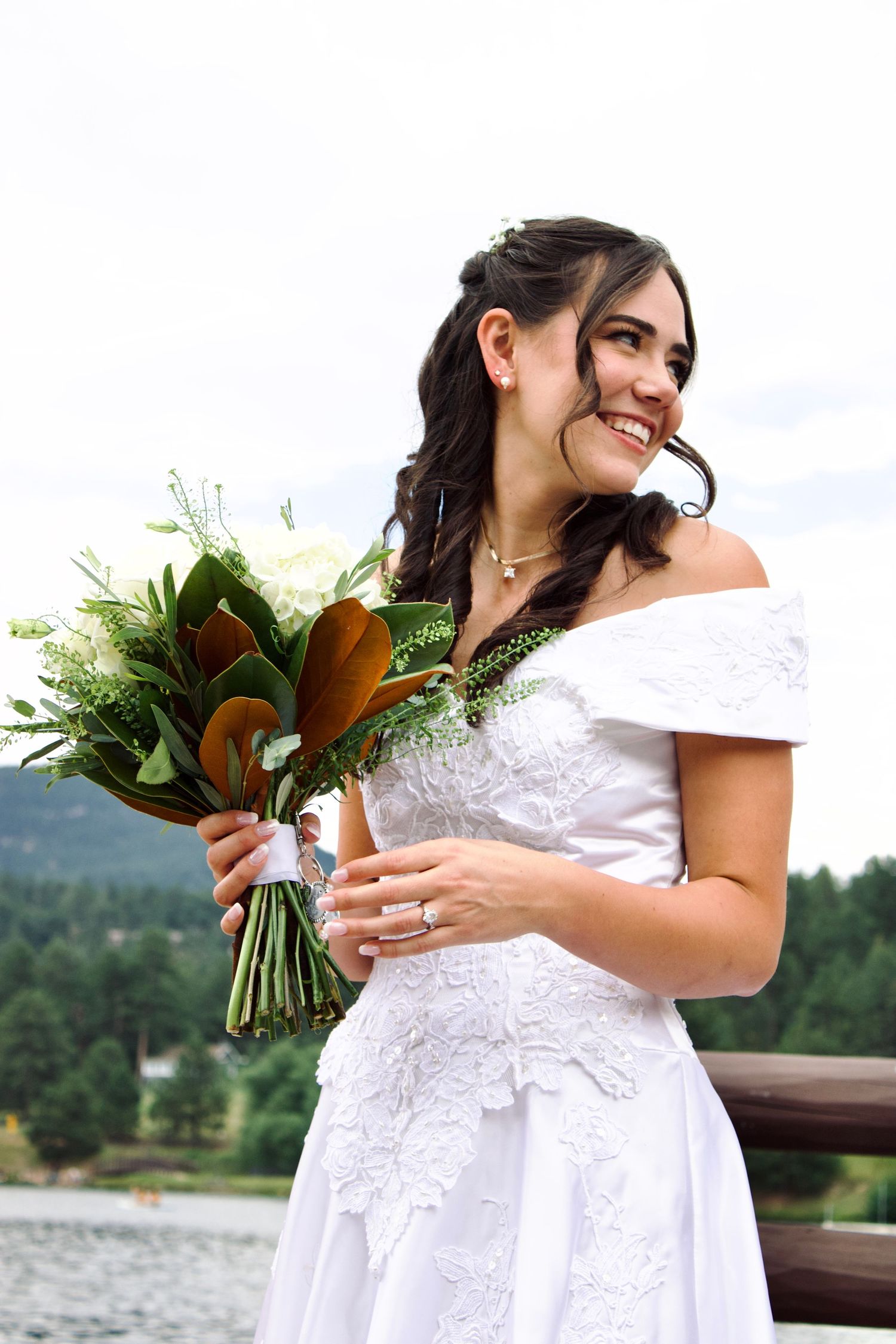 A series of four shots showing someone in a white wedding dress holding a bouquet against a scenic lakeside backdrop.