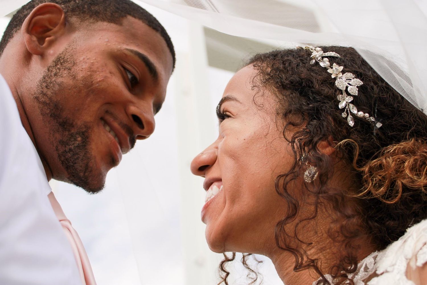 Intimate black and white wedding portraits showing joyful expressions.