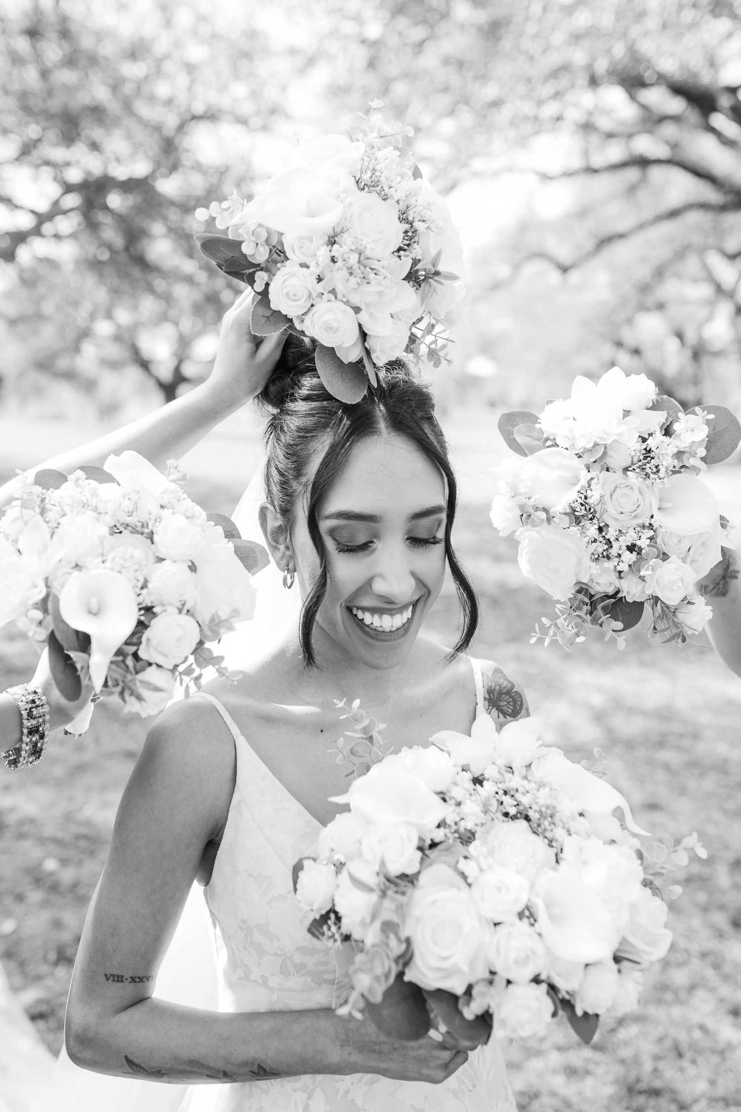 A dreamy black and white photo series showing a person in a romantic pose among blooming cherry blossoms.