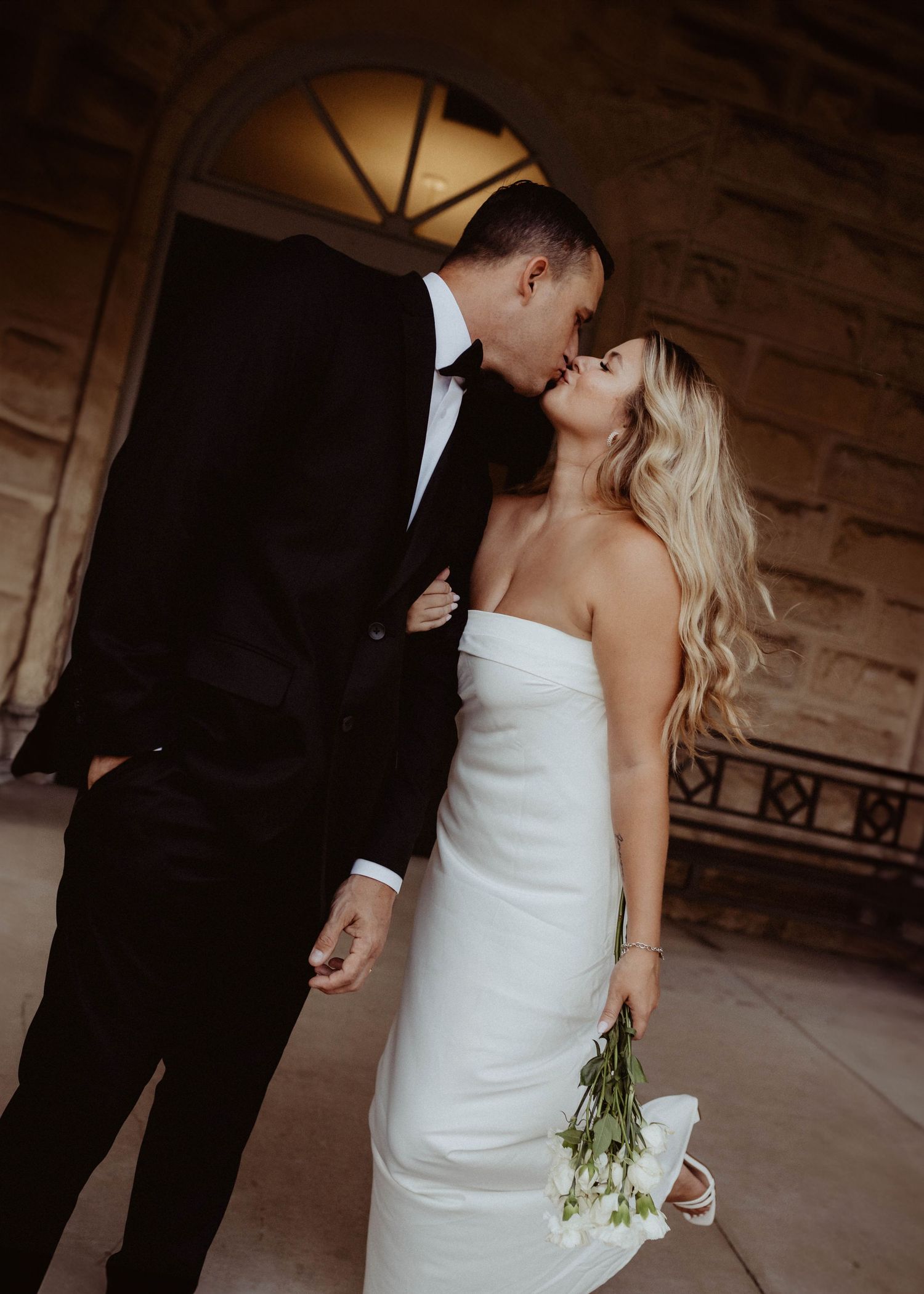 A romantic series of wedding photos showing a couple in formal attire sharing tender moments in an elegant venue.