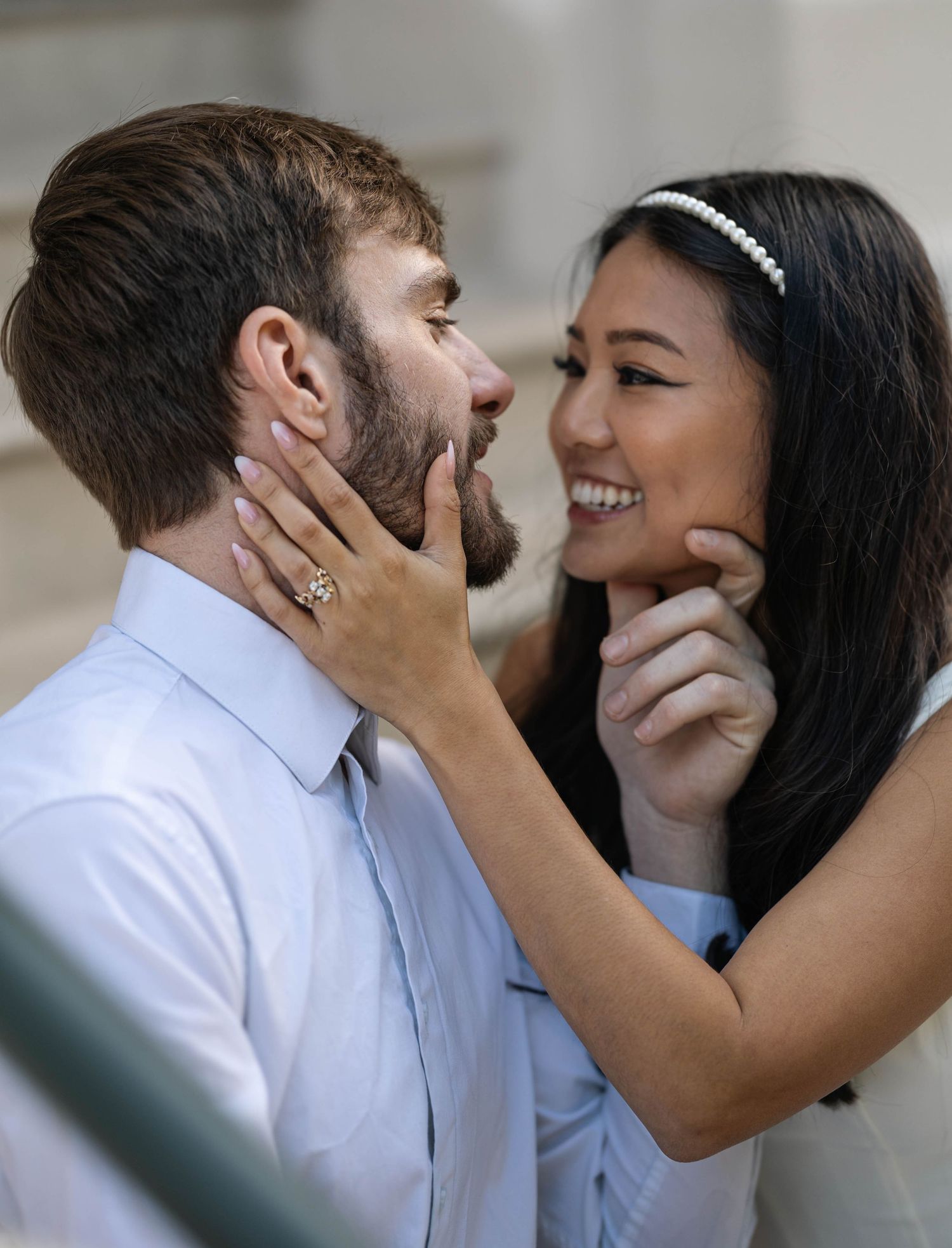 Happy couple sharing a tender moment, woman smiling and holding mans face.