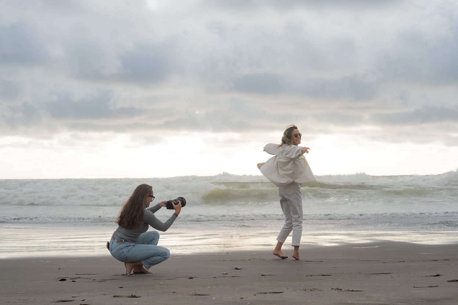 A series of candid beach photos showing people walking and playing in the sand against a cloudy oceanfront backdrop.