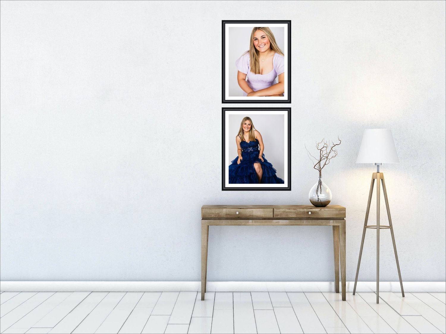 Interior wall design with two framed portraits of senior Maddy Shier hanging above a wooden console table and modern floor lamp.