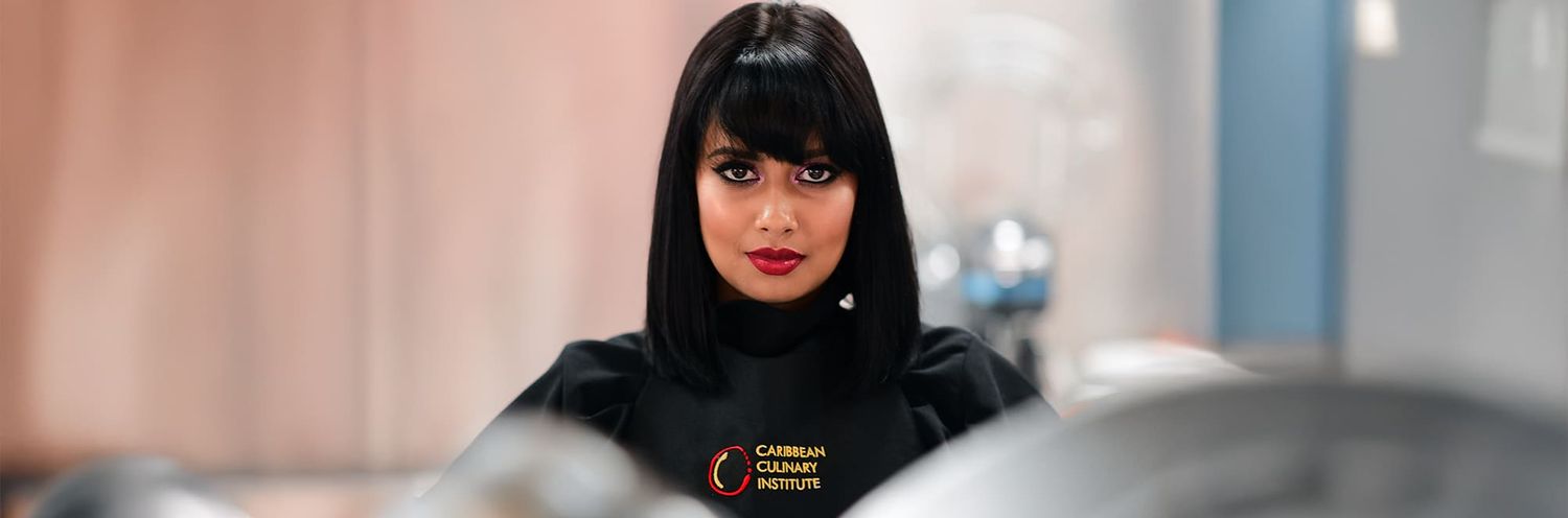 A person in a black hijab looks directly at the camera with a blurred background.