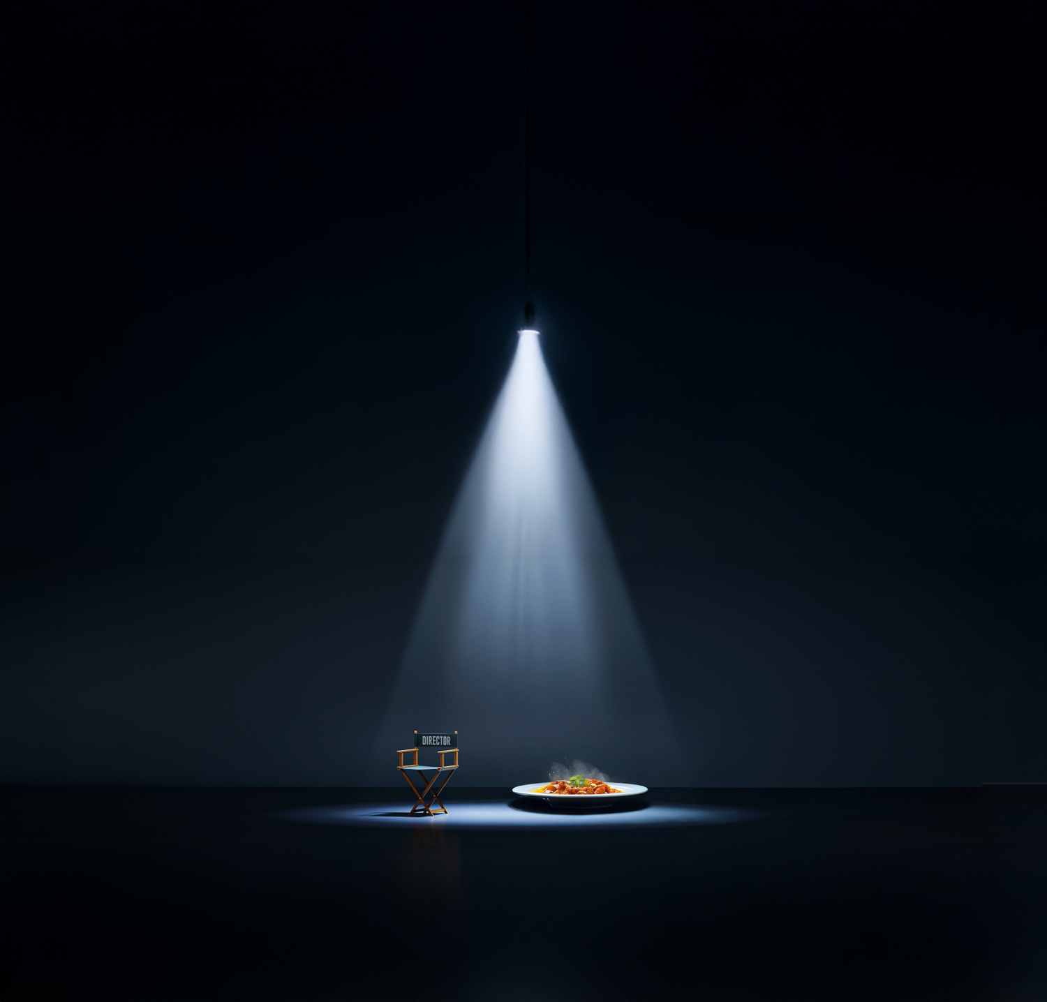 A dramatic spotlight illuminates a solitary chair and plate in a dark room creating a moody theatrical scene.