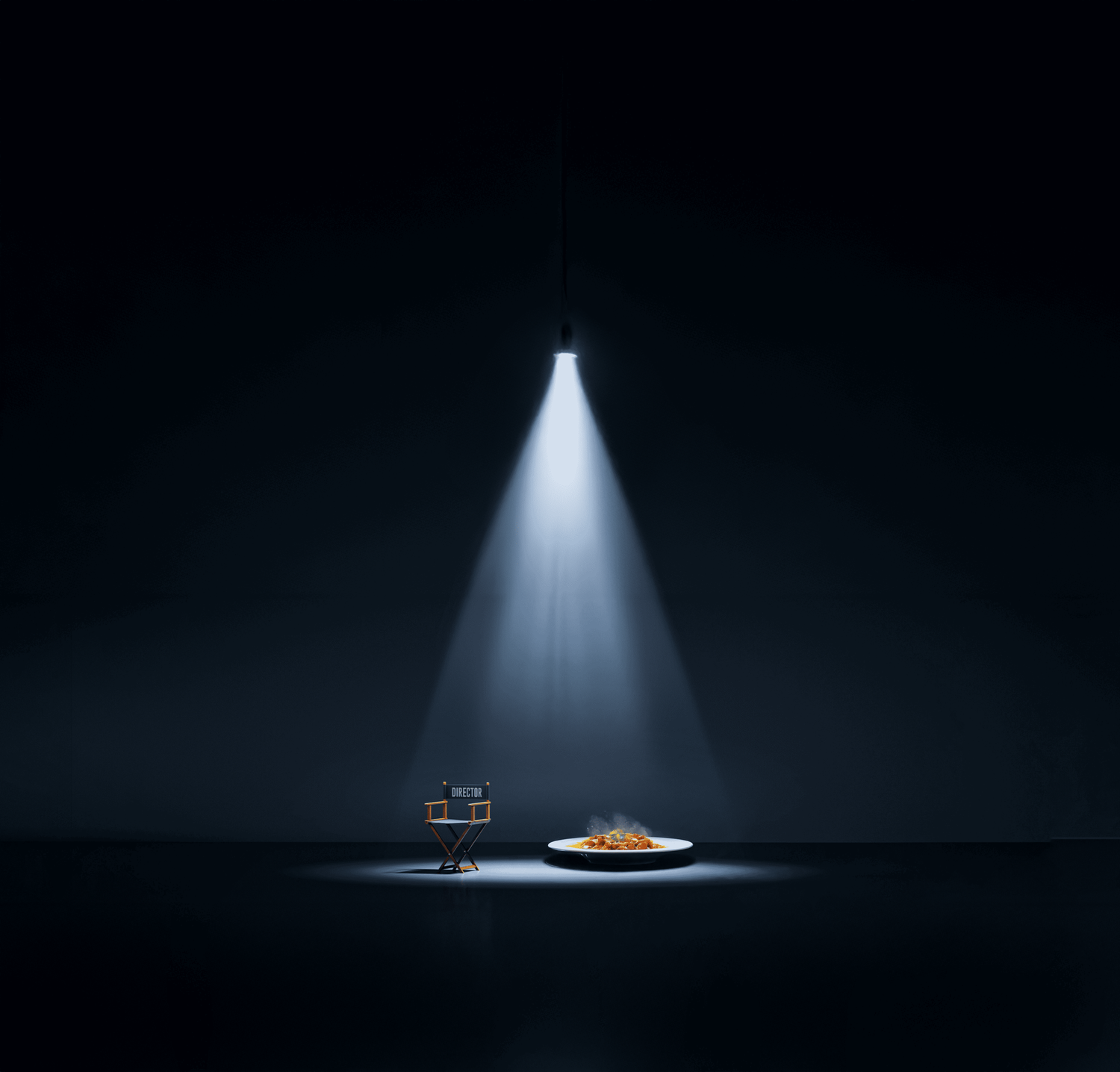 Single spotlight beam illuminating plated dish and glass on dark surface.