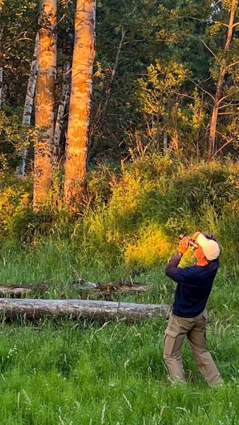 Photographer Mark Swanson using his camera in nature.