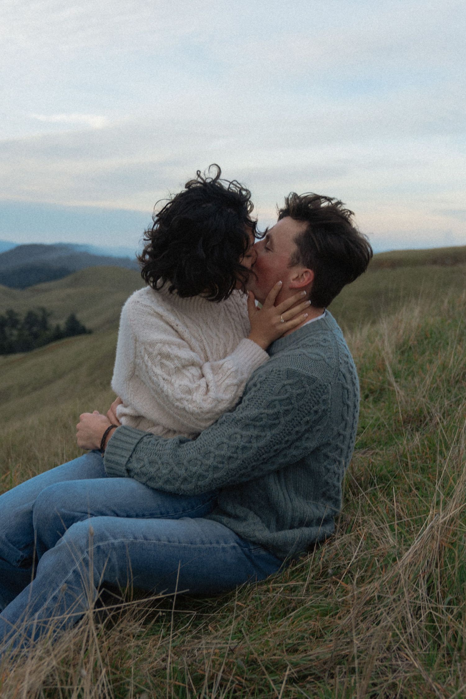 Couple kissing on mount talampais for engagement session