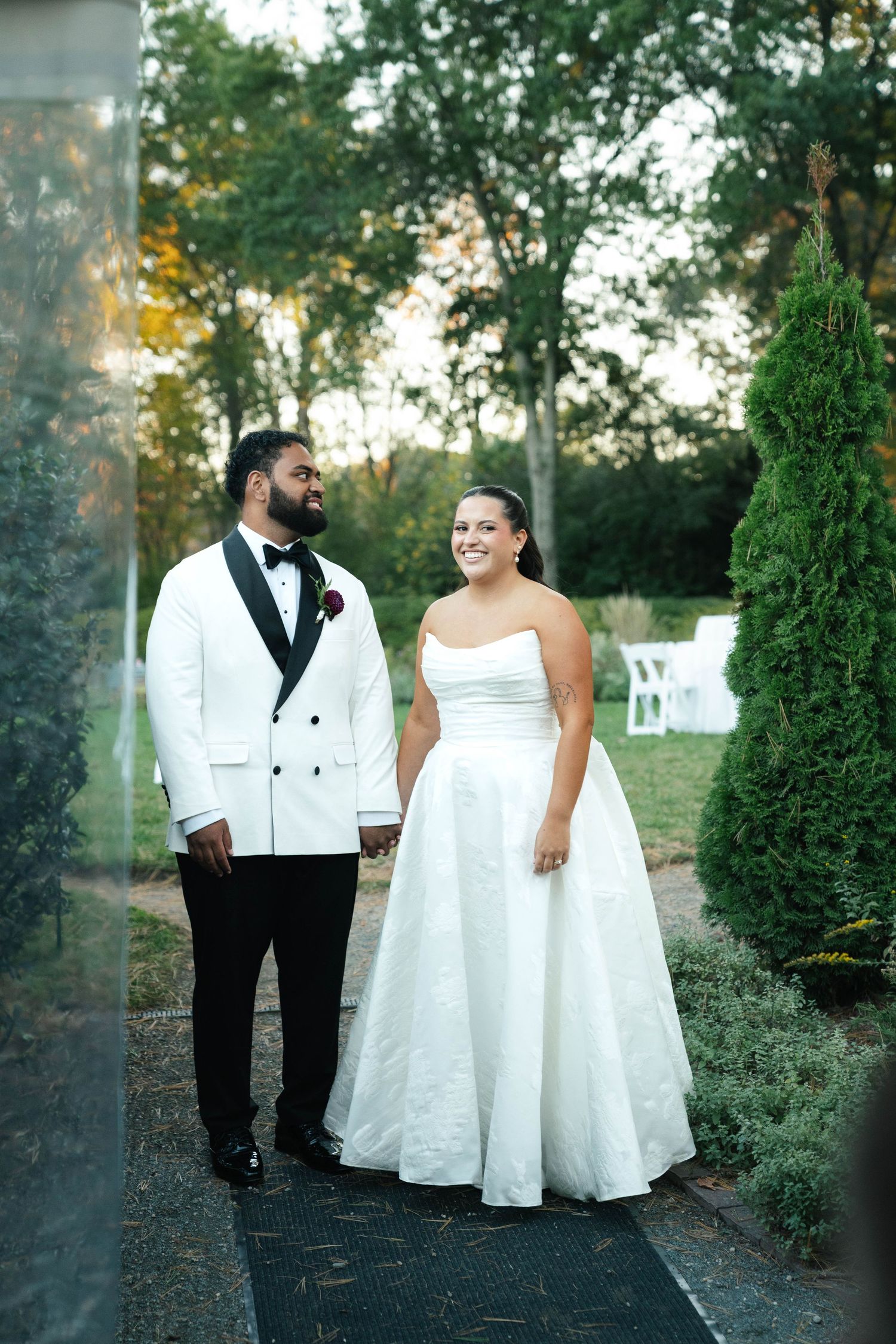 Documentation of bride and groom giggling with each other before their grand entrance at their wedding in Boston, Massachusetts