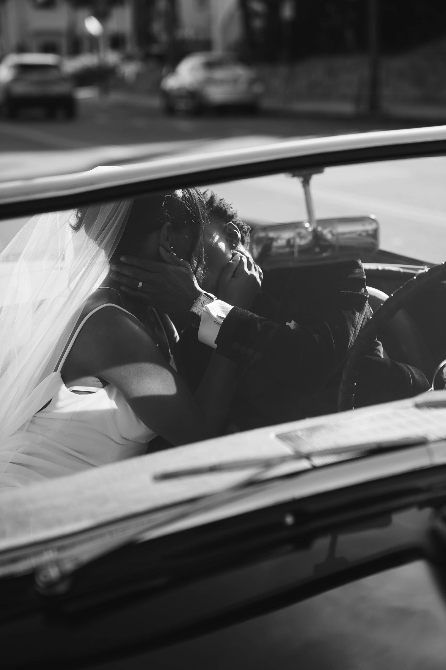 bride and groom kissing in their vintage car in Santa Barbara California