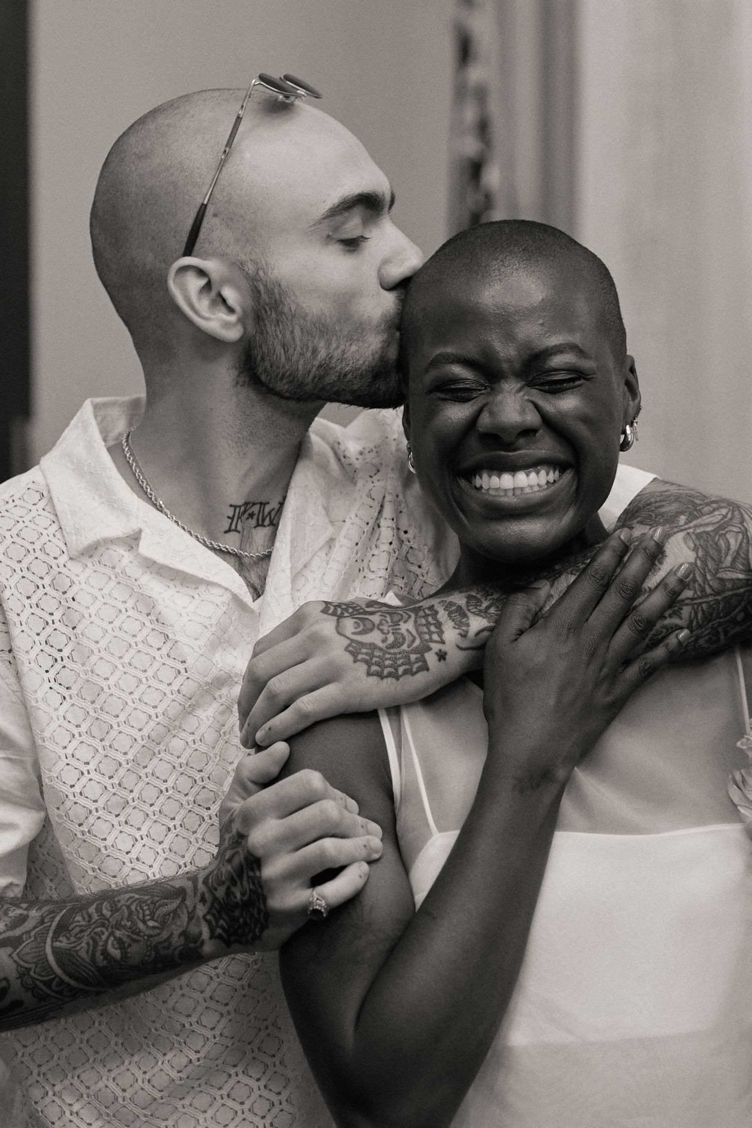 An intimate black and white portrait of a loving couple embracing and showing joy at their New York City Hall Elopement session.