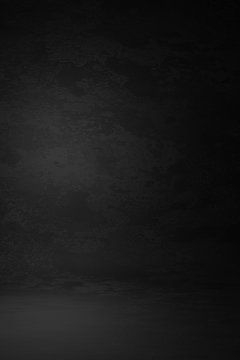 Dark black textured studio background with subtle light gradient, ideal for product photography or dramatic design projects.