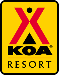 KOA Resort logo featuring a bold red X, black triangle, and yellow background with black text.