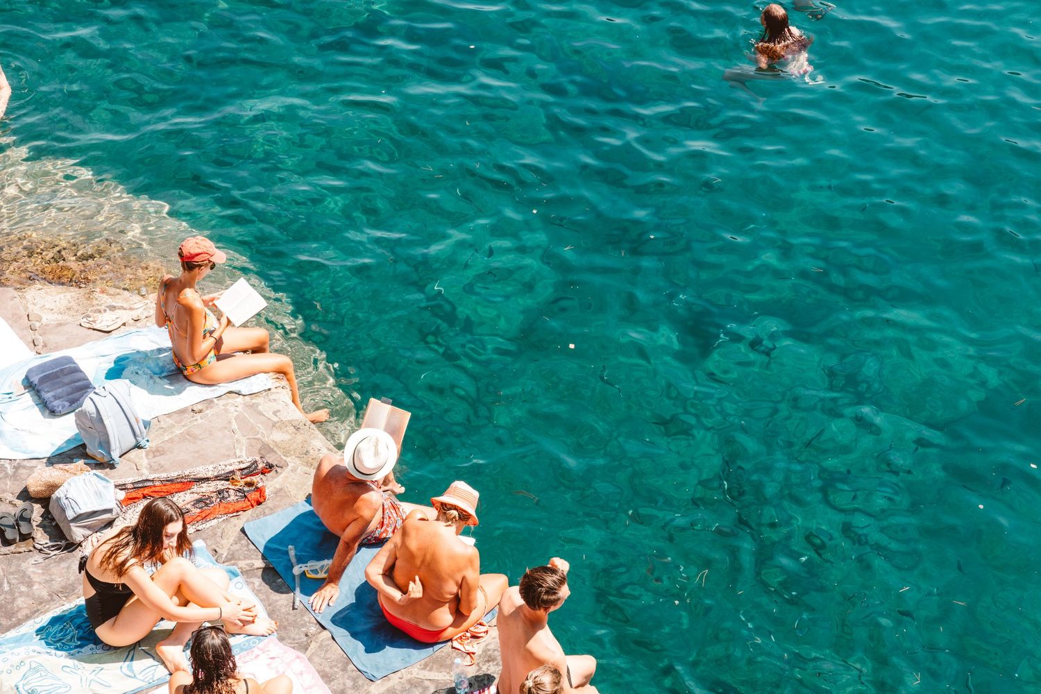 Group of people sunbathing in Portofino, Italy