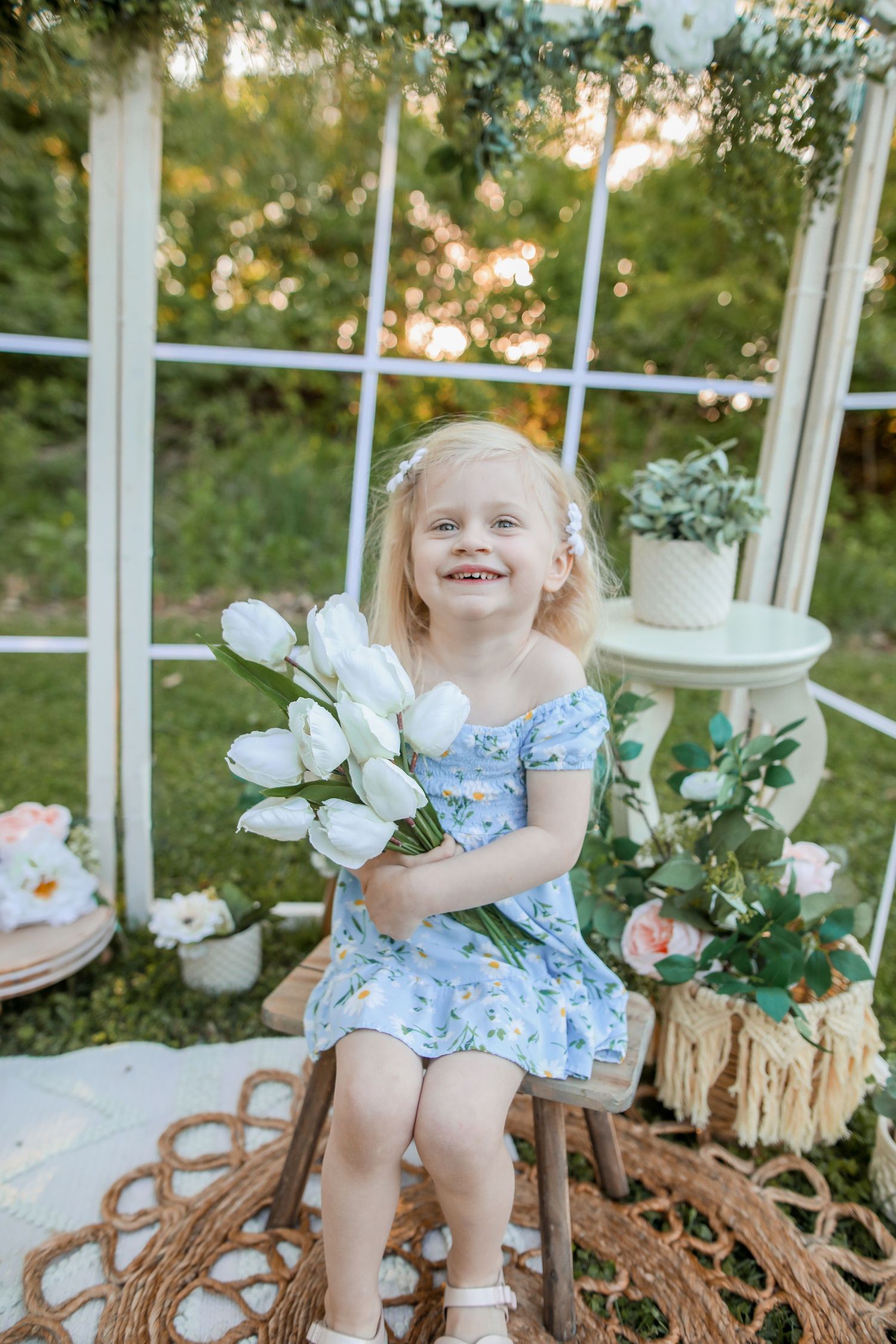 Spring garden scene with white floral decorations and vintage furniture.