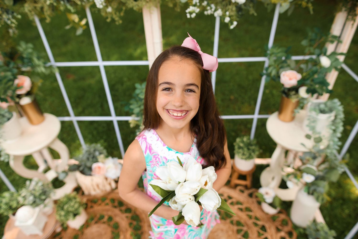 Garden photoshoot setting with white flowers and decorative elements.