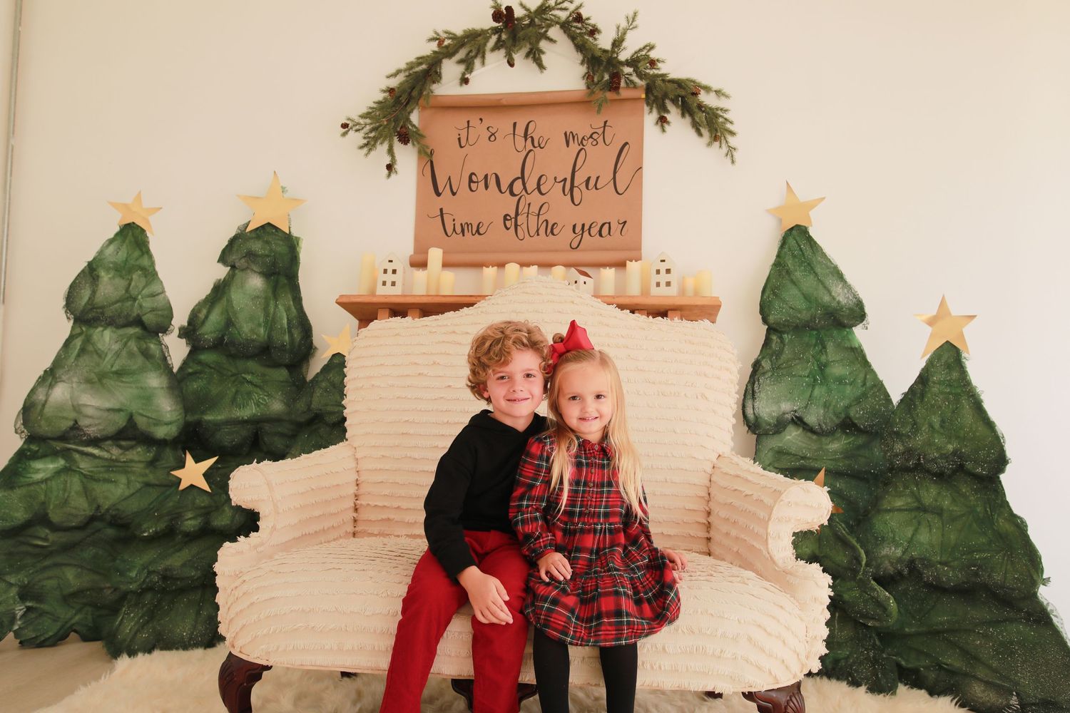 Whimsical winter scene with painted green trees and rustic wooden signs on white backdrop.