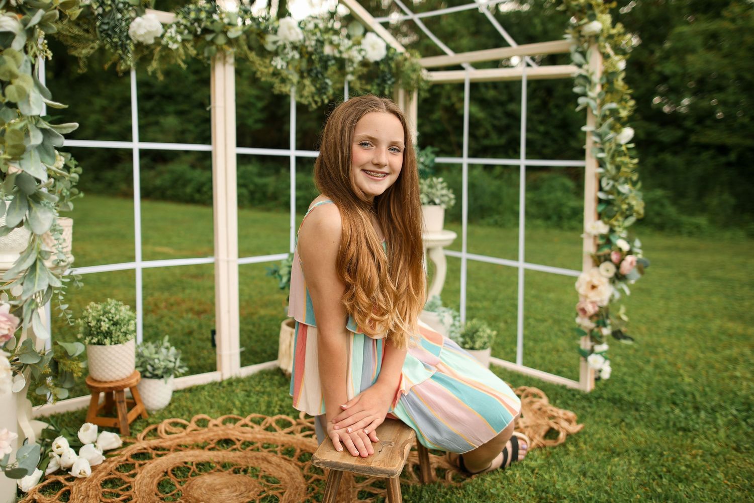 Garden scene with white trellis backdrop decorated with romantic floral arrangements.