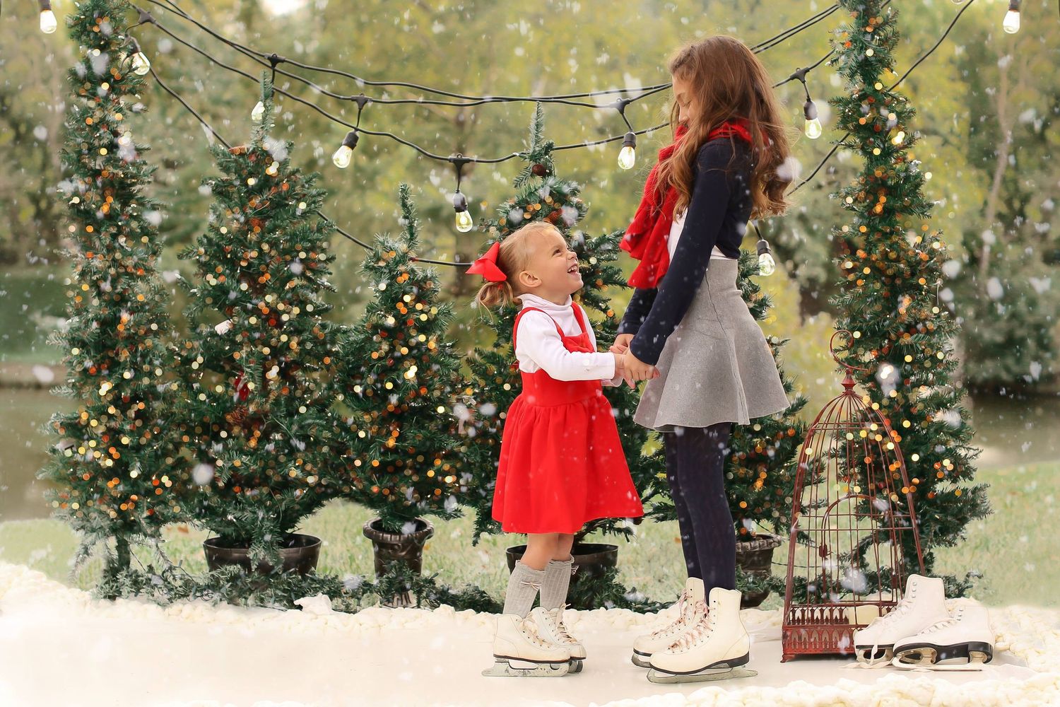 Ice skating scene with decorated Christmas trees and string lights in background.