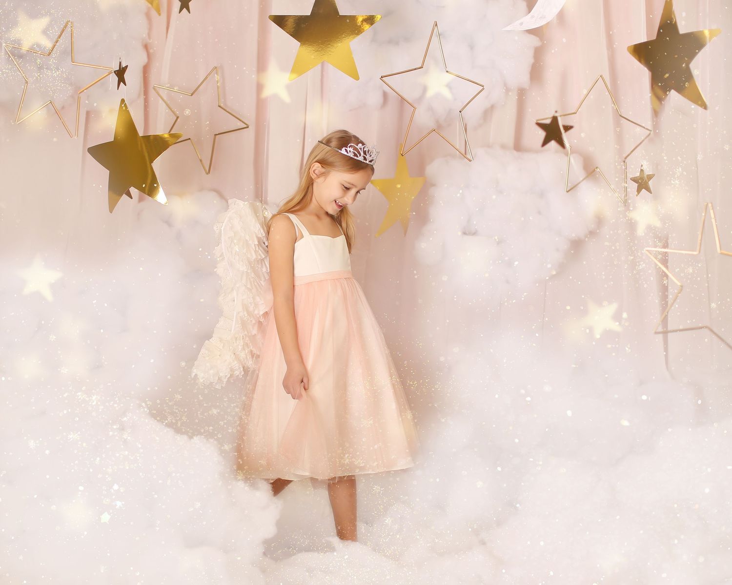 Dreamy portrait setup with golden stars and clouds featuring a light pink dress against a soft ethereal backdrop.