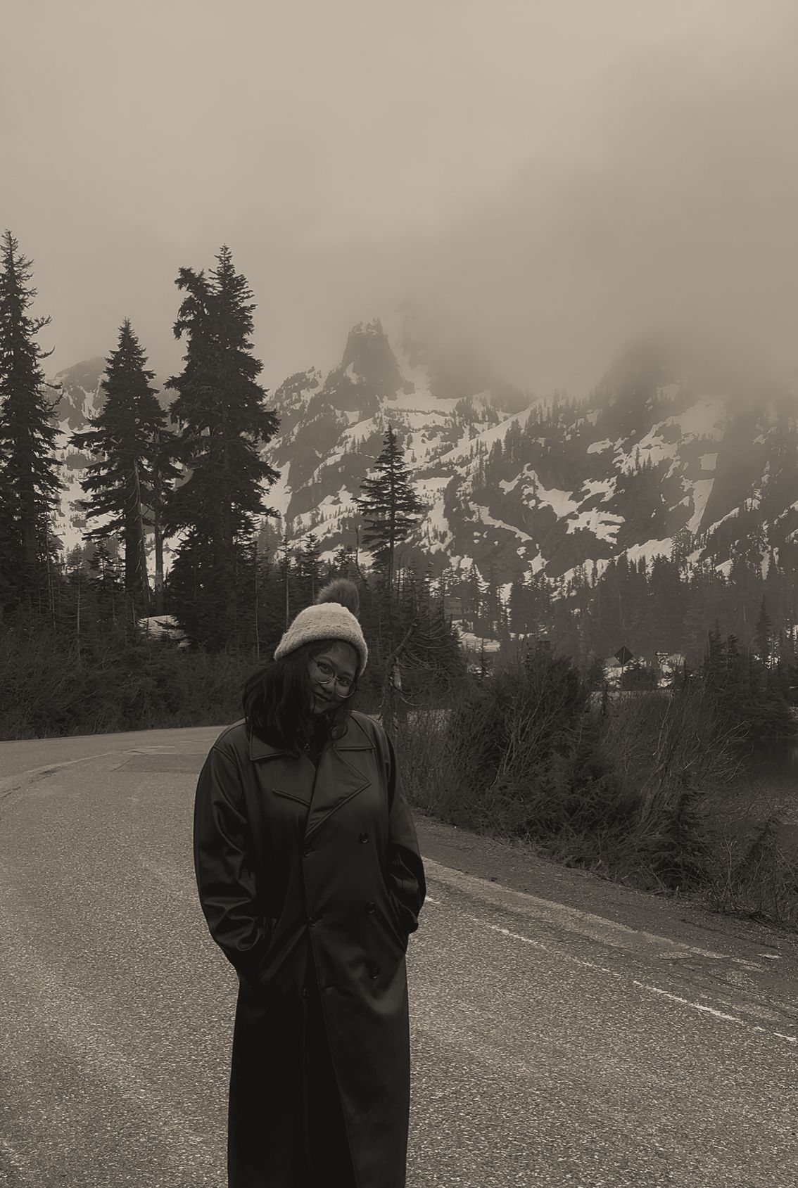 Three black and white photos show a winter scene with a lone figure standing in a snowy mountain landscape with evergreens.