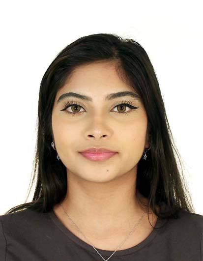 Professional studio portrait of a woman with dark hair wearing a black top and minimal jewelry against a white background.