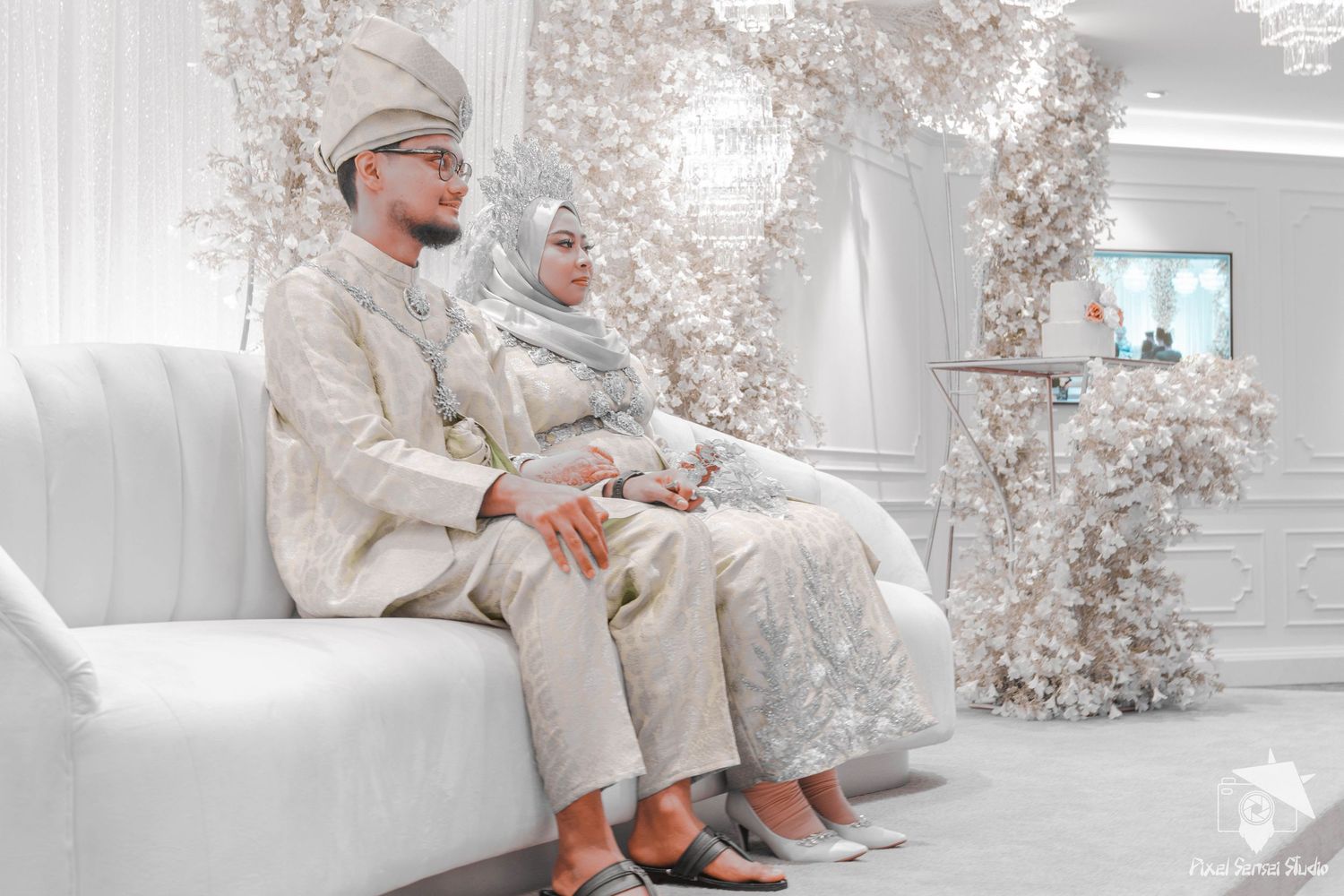 Elegant white and beige wedding setting with floral decorations.