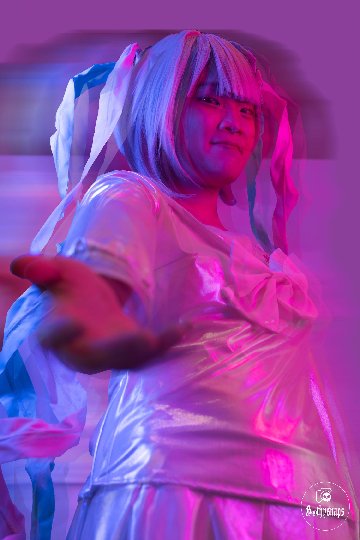 Kangel Cosplayers showing a blured motion vision of her giving her hand to you.