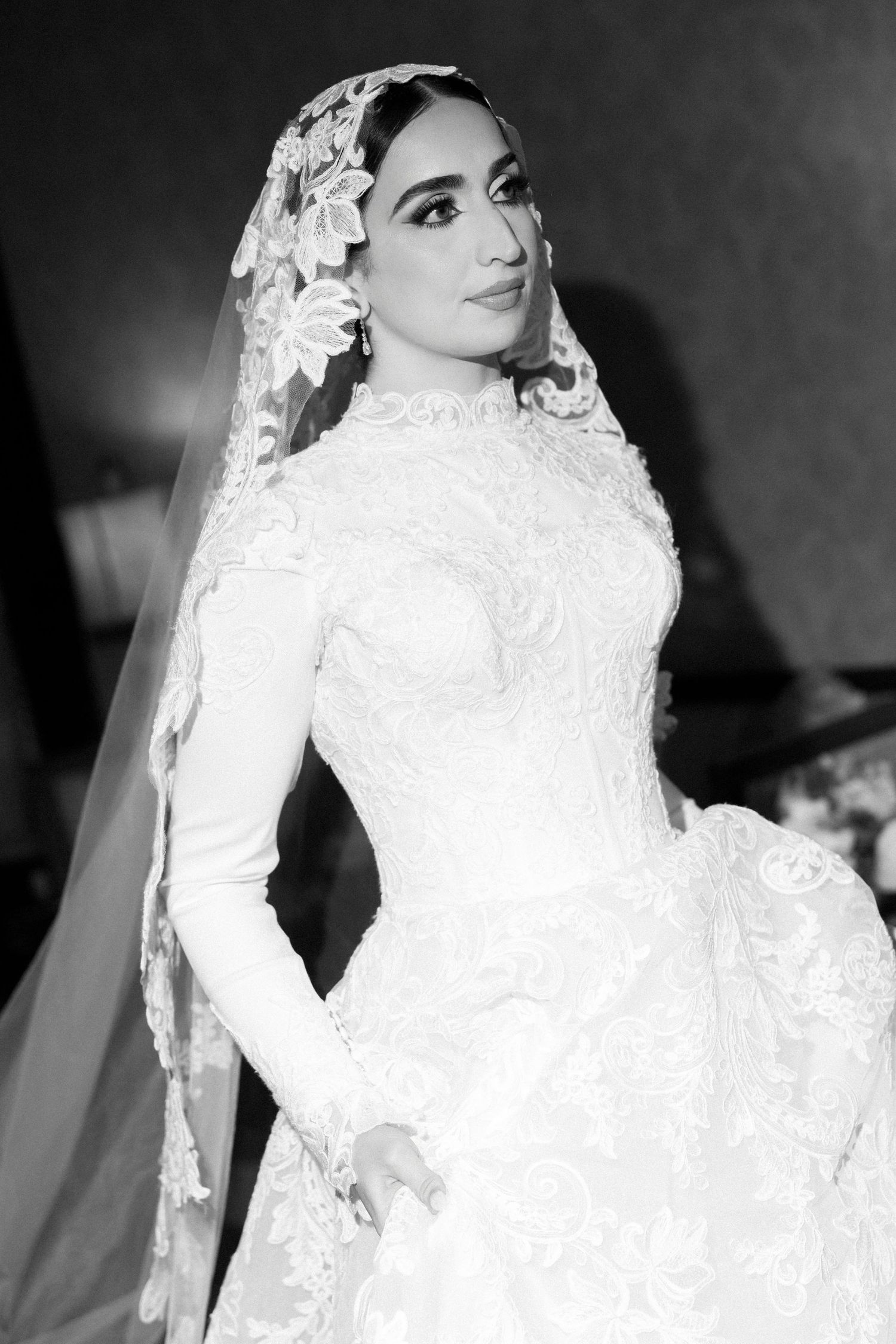 A series of elegant bridal portraits in black and white showing a wedding dress with intricate lace details and long sleeves.